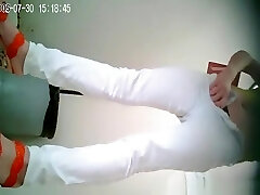 Asian woman in white trousers pissing