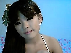 Japanese cutie Mina poses for her webcam demonstrating her little