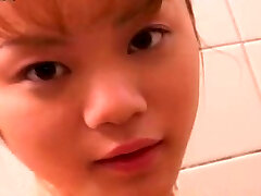 Cute petite Japanese girlie takes bathroom flashing her nice backside and titties