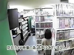 Asian woman watching pornography and masturbating in video room