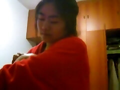 Japanese girl with big boobs changes clothes in her bedroom