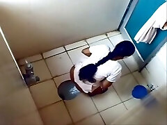 Some amateur Indian brunette gals peeing in the toilet on hidden cam web cam