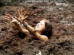 Handcuffed female gets stuck in deep mud