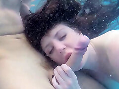 Super adorable babe gives eager blowage under the water