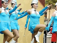 Scorching young majorettes in blue flash their sexy gams as they