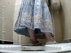 White mature lady in sundress pisses in the toilet room