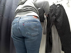 In a fitting room in a public supermarket, the camera caught a chubby milf with a gorgeous ass in semi-transparent panties. PAWG.