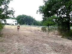 A chained slave is punished to dance nude on the highway