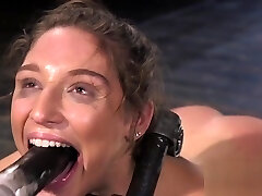 Trussed brunette endurs pain from huge dildo