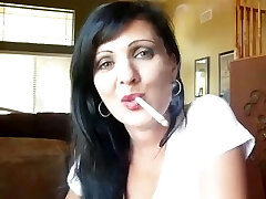 sexy brunette dangles her cigarette