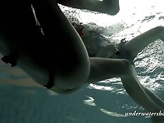 Two super-sexy stunners swimming in a pool in arousing Underwater show
