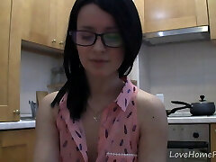 Splendid teen with glasses conversing in the kitchen
