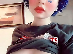 Depressed butterfly punk girl plays with her boobs