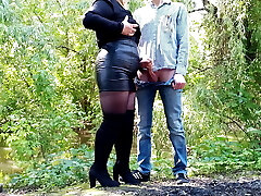 MILF in leather miniskirt gets a load on her bum outdoors