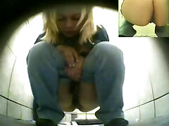 Unsuspecting blonde on hunkers pissing in a toilet