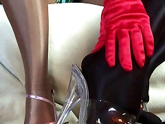 Sensual teasing close up legs and feet in Shiny glossy pantyhose and high stilettos. Sensual teasing close up legs and feet in Shiny glossy pantyhose and high stilettos.