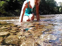 Sexy t-girl swimming in mountain river and wetting teal summer dress ...