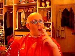Bald and smoking in rubber cape