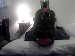 Laura is hogtied in tourist resort catsuite and high heels, throated with a lip open mouth gag POV