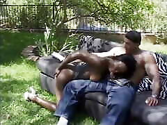Superior well shaped black blows dick on the sofa outdoors