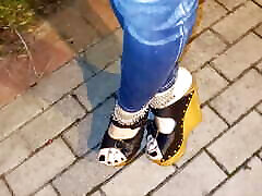 a crossdresser with amazing feet walks on the street in high heel wedges and tight jeans and tempts guys
