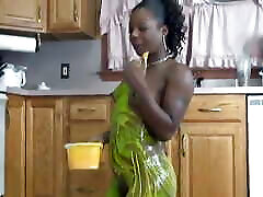 Black chick rolls around in color on kitchen floor