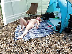 A young blonde wife is tiger sek and masturbating on a British public beach