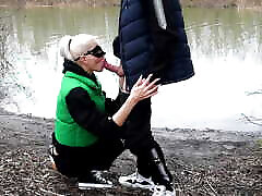 Blowjob in a public place on the bank of the river and cum in the mouth stinky retros on the face of this sexy