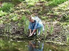 A Blonde with Braids Rund Through a Field Until She Finds Two Cocks to Suck