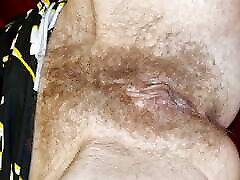 I lie with my legs spread, showing my pussy and exposed tits, and I smoke a cigarette