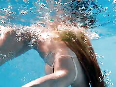 Big boobs blonde babe swimming