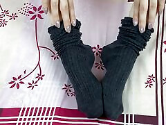 Girl in gray long socks on her legs caresses herself in bed Girl in gray long socks on her legs caresses herself in bed