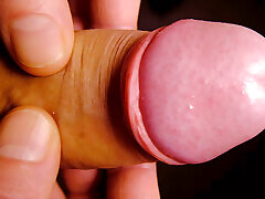 Very Close up on the tip of his uncut penis as he plays with his foreskin and show bell-end