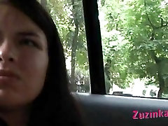 Zuzinka plays with her fake tree com in a taxi