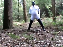 in wood in white zentai and rubber boots