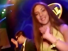 Hot Latina in a sexy yellow dress dancing in the club