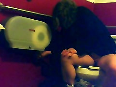 mild ssolo unsuspecting female sitting on a toilet