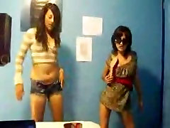 Stunning young brunettes dancing to music and stripping
