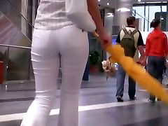 Beauty in tight white pants stars in a candid girls on glass video