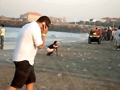 A fresh boozed girl pissing in public on the beach