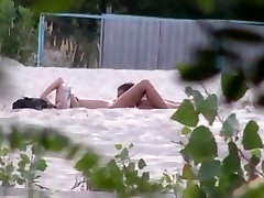 Voyeur tapes 2 nudist couples having nude amacutie at the beach