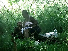 Voyeur tapes a black girl couple having sex on bench in the park