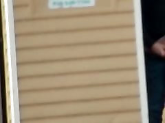 Dude jerks off behind porta theif or cop in public park