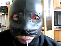 Slave gives blowjob in leather mask