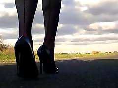 Walking in black patent hells fishnets and black tight skirt