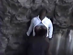 Guy fucks a black girl near rocks