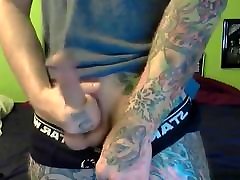 Tattooed gay jerks of in front of a cam