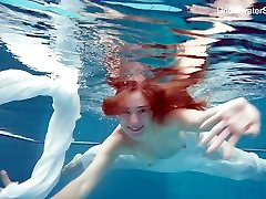 Sweet looking red haired hottie Diana Zelenkina is stripping under the water