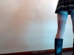 Crossdresser in mini skirt schoolgirl and boots.