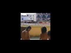 Latinas expoing on rooftop swimming pool Latinas expoing on rooftop swimming pool